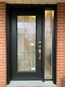 Black door with one sidelight, offering a sleek and modern addition to home design