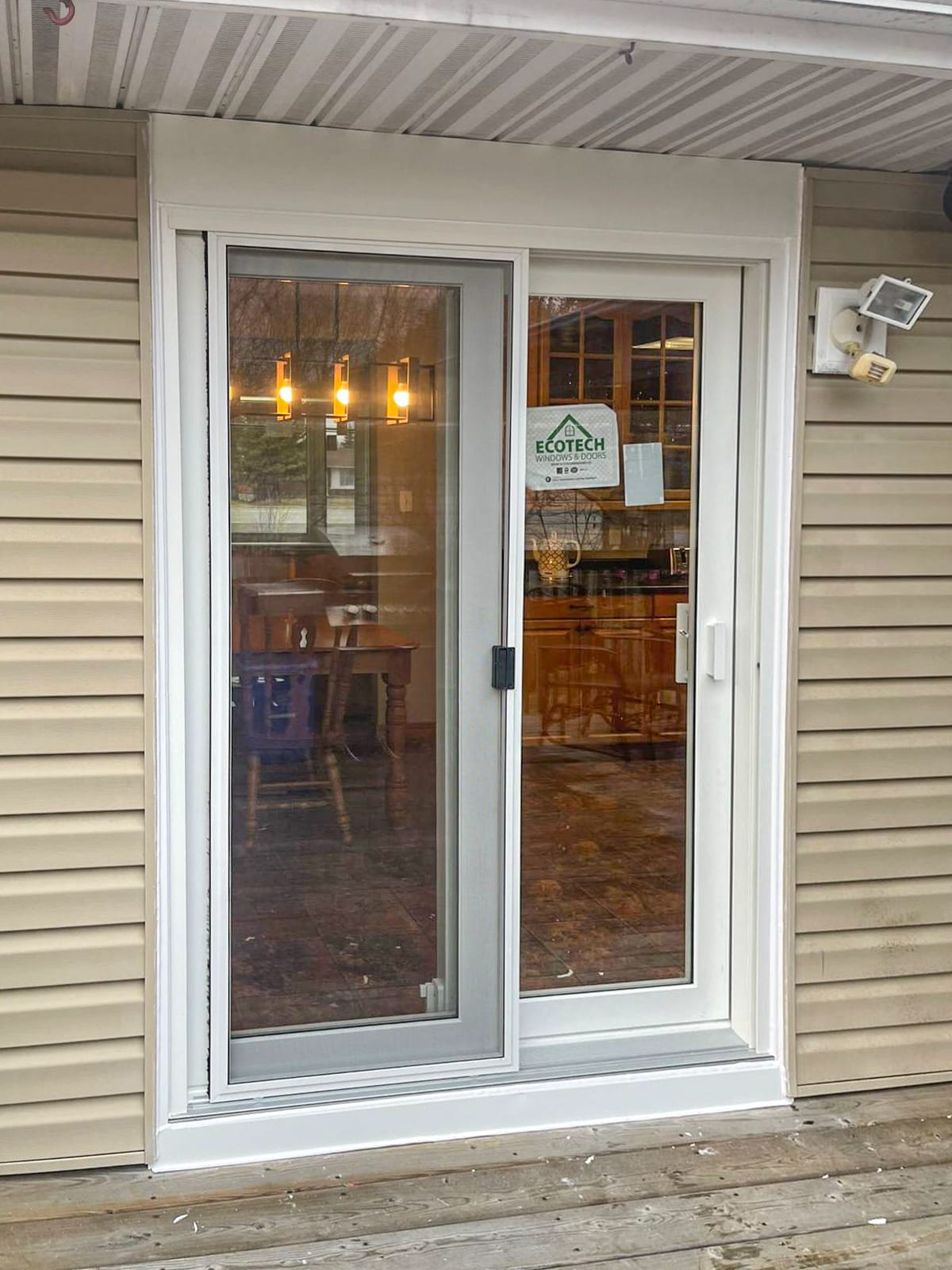 White patio door with attached screen bringing natural light and outdoor views
