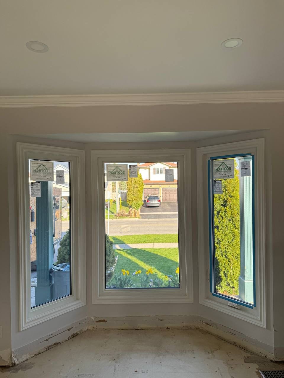 Bay window allowing abundant natural daylight into the room, highlighting the interior space and offering views of the outdoor surroundings during daytime.