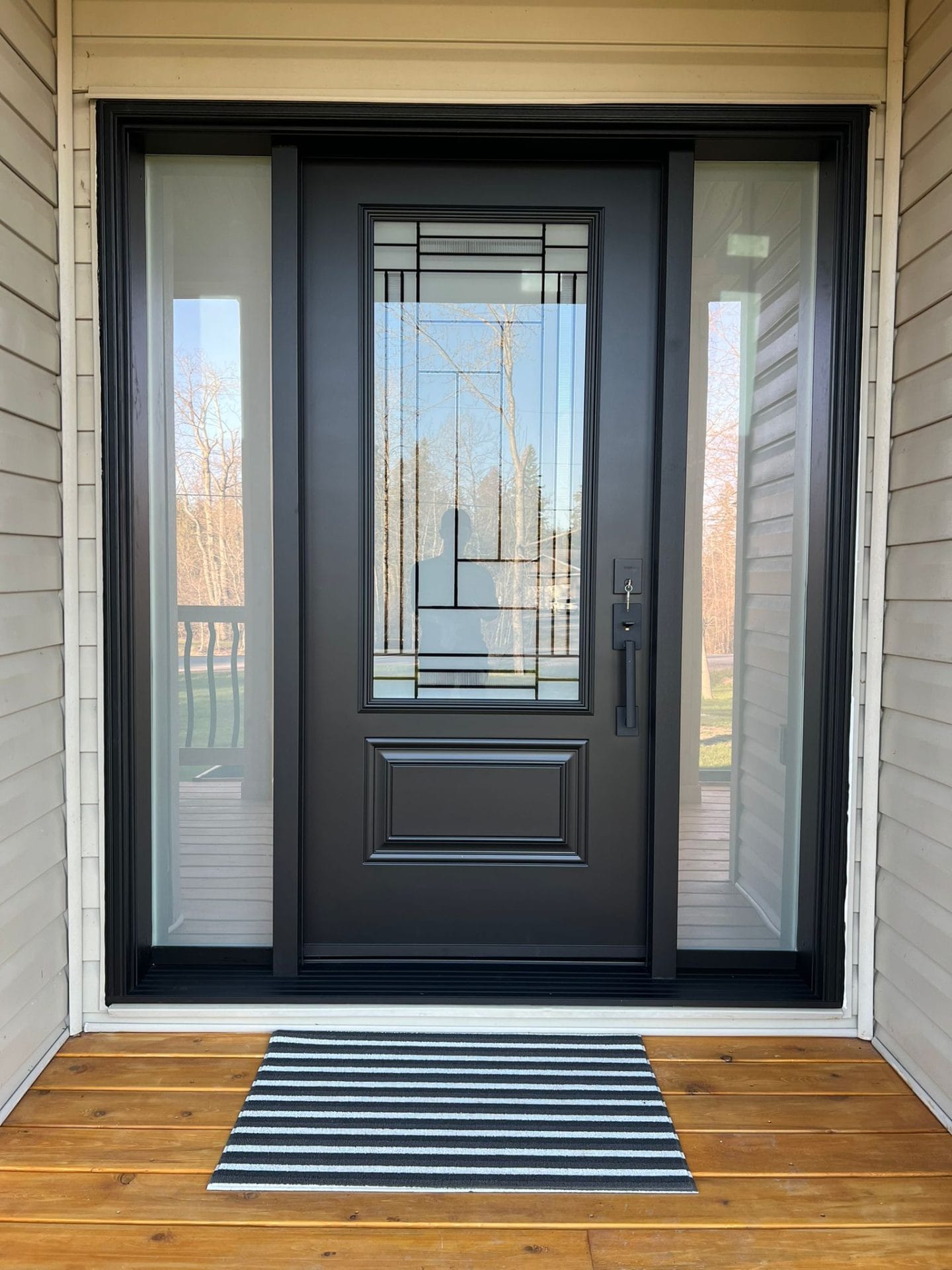 A black door with privacy glass for natural light on sides and on door