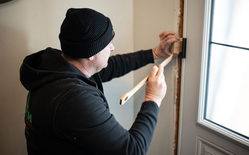 Using shims to balance out a new entry door installation.